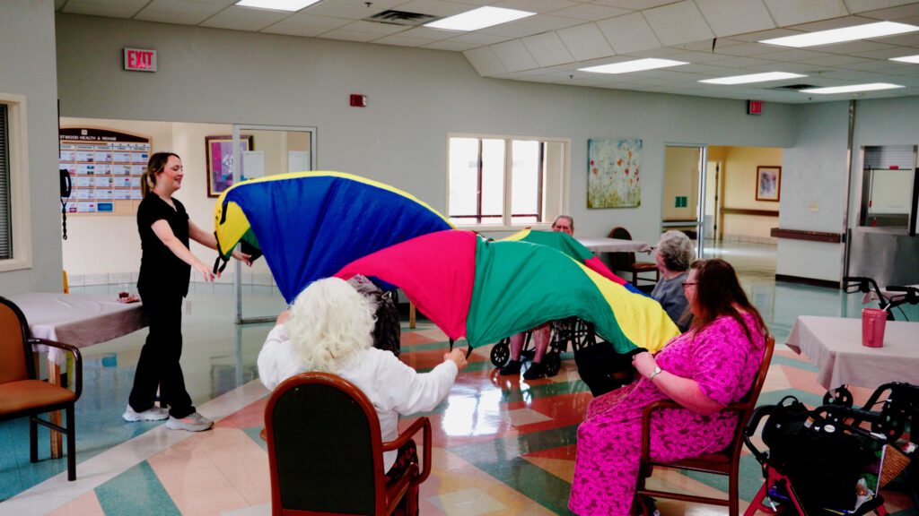 A group of residents play a game at a skilled nursing home