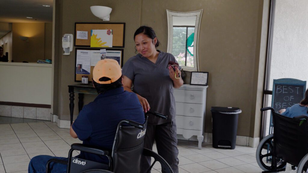 A nurse smiling at a man during a respite care visit